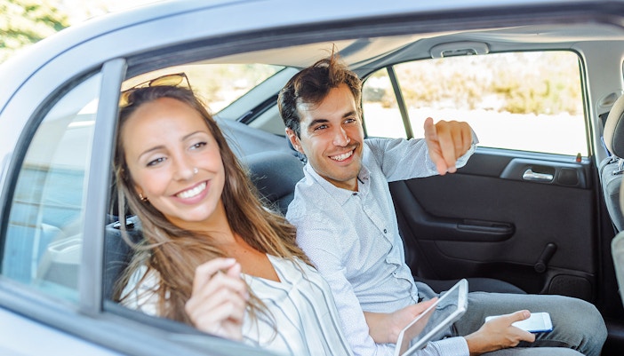 Couple sitting in the back seat of a car