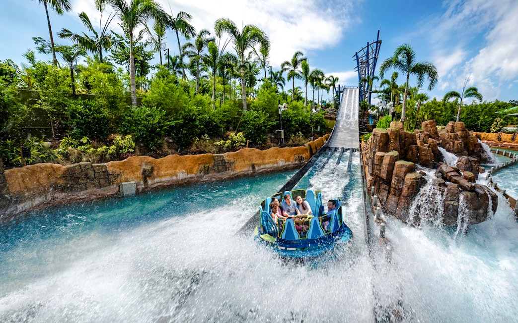 Raft descending the Infinity Falls river rapids ride at SeaWorld Orlando.