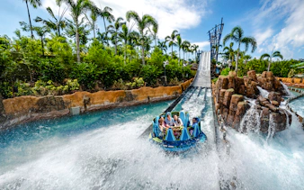 Raft descending the Infinity Falls river rapids ride at SeaWorld Orlando.