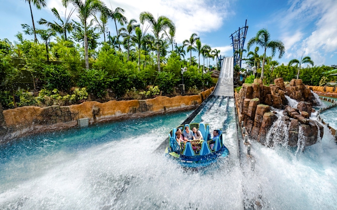 Raft descending the Infinity Falls river rapids ride at SeaWorld Orlando.