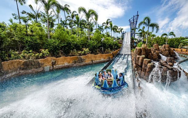 Raft descending the Infinity Falls river rapids ride at SeaWorld Orlando.