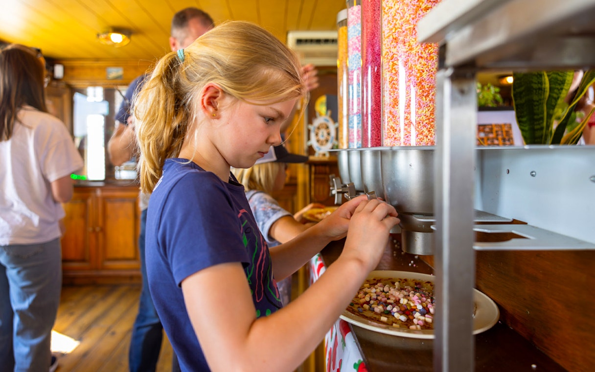 Guests adding toppings to pancakes on a cruise in Rotterdam.