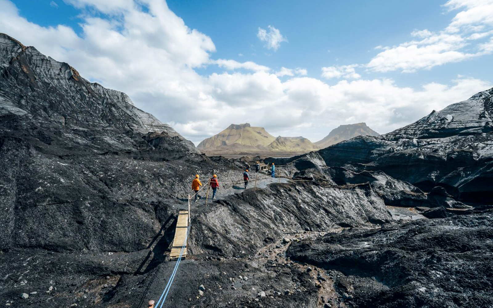 Guests walking on a path near Katla Ice Cave in Iceland.