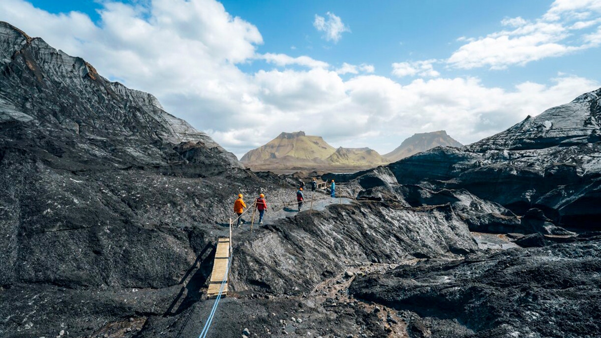 Guests walking on a path near Katla Ice Cave in Iceland.