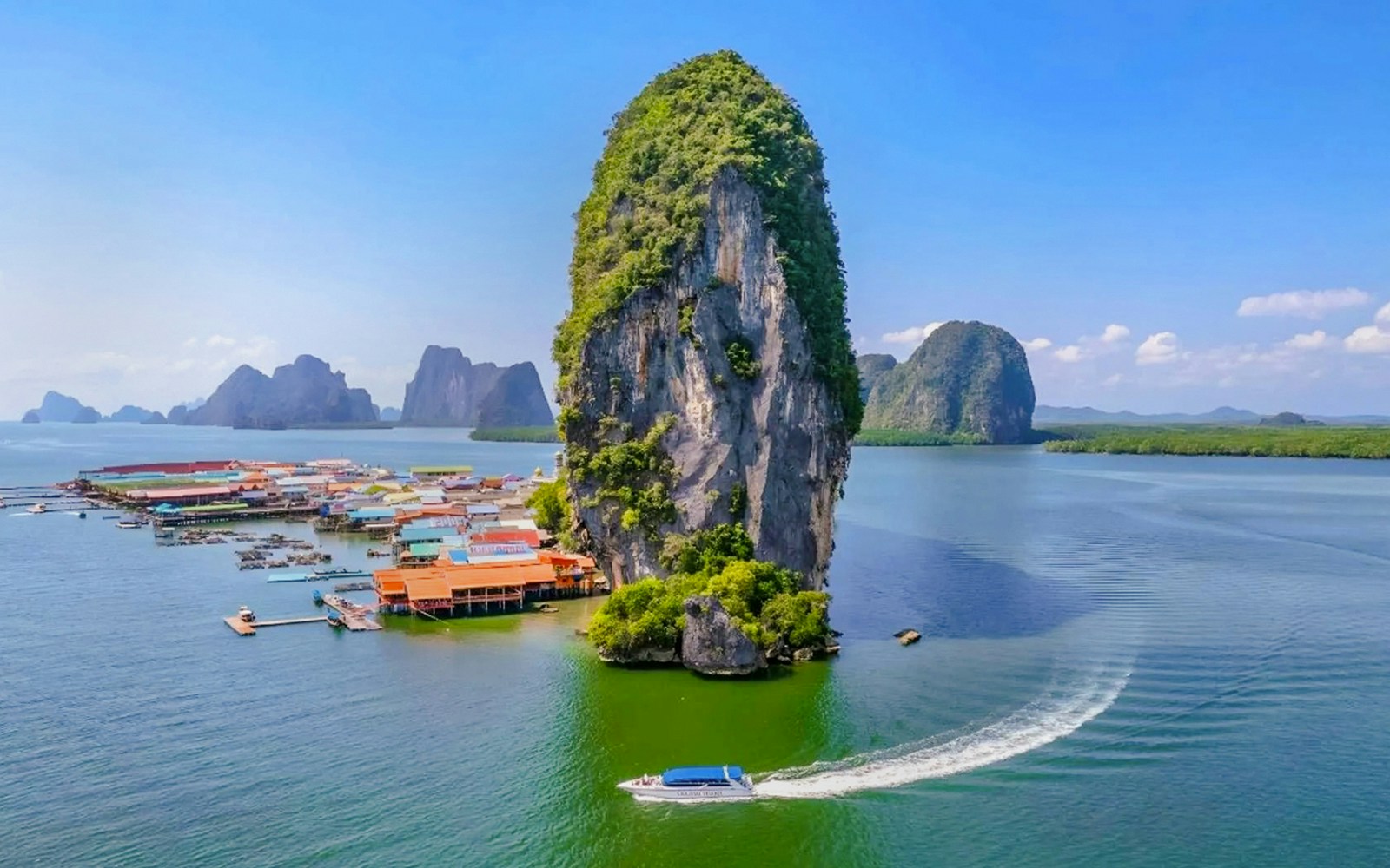 Aerial view of Ko Panyee island with limestone cliffs and village in Phang Nga Bay, Thailand.