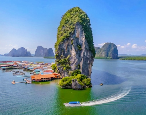Aerial view of Ko Panyee island with limestone cliffs and village in Phang Nga Bay, Thailand.