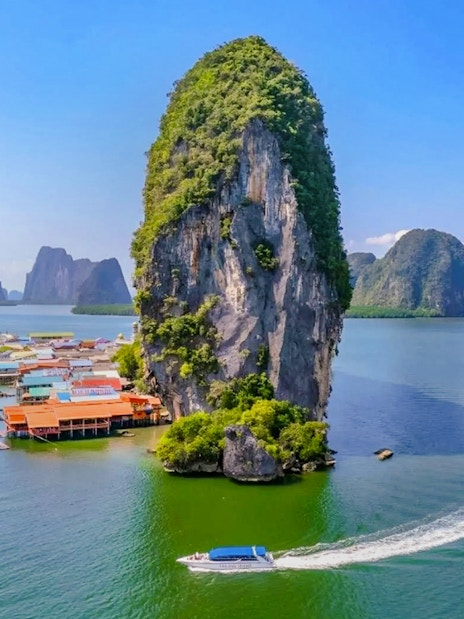 Aerial view of Ko Panyee island with limestone cliffs and village in Phang Nga Bay, Thailand.