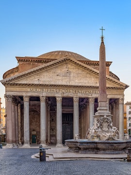 Pantheon in Rome with ancient columns and fountain in foreground.