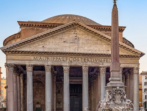 Pantheon in Rome with ancient columns and fountain in foreground.