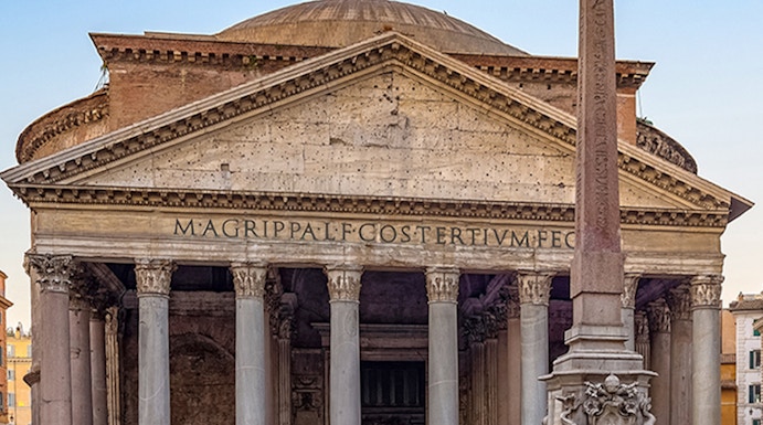 Pantheon in Rome with ancient columns and fountain in foreground.