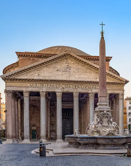 Pantheon in Rome with ancient columns and fountain in foreground.