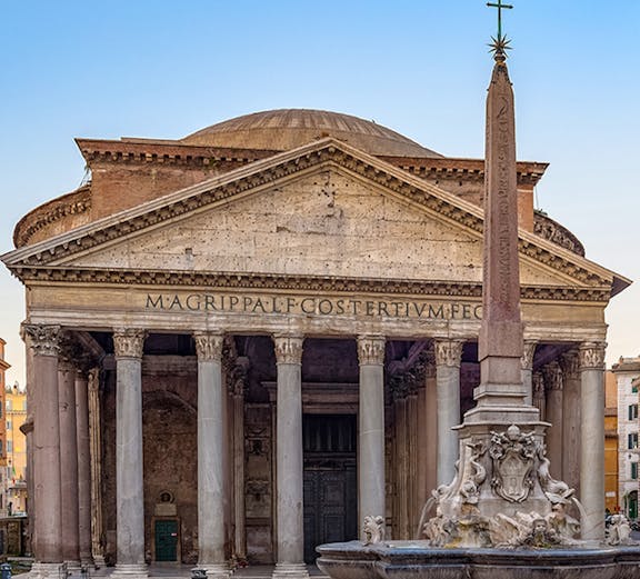 Pantheon in Rome with ancient columns and fountain in foreground.