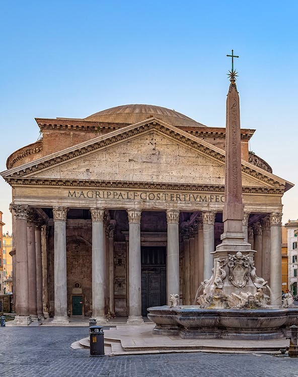 Pantheon in Rome with ancient columns and fountain in foreground.