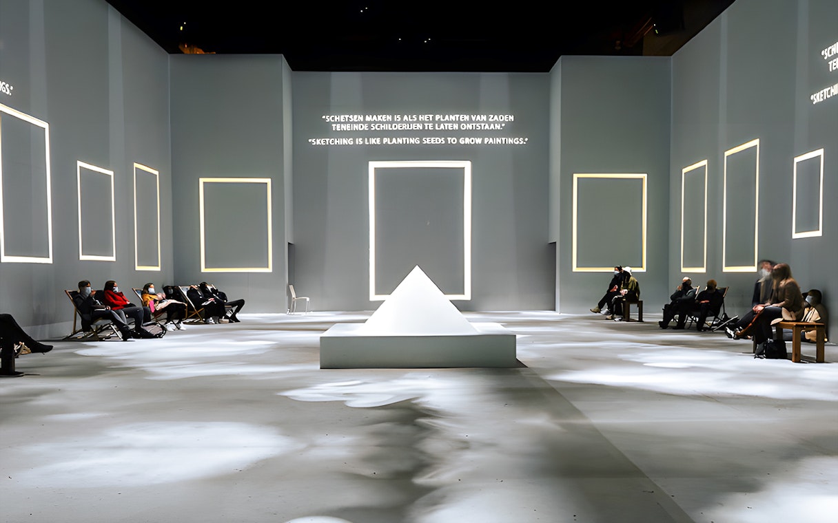 Guests seated at Van Gogh Exhibition in London, viewing illuminated quotes and frames.