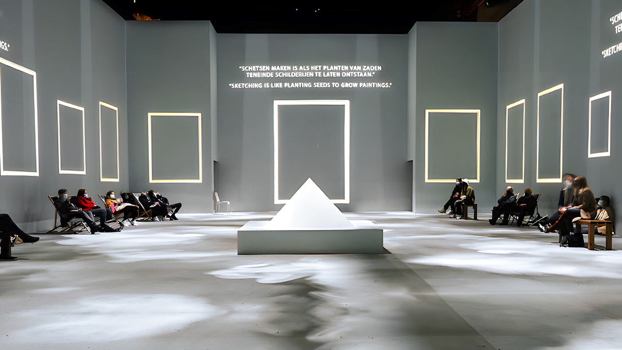 Guests seated at Van Gogh Exhibition in London, viewing illuminated quotes and frames.