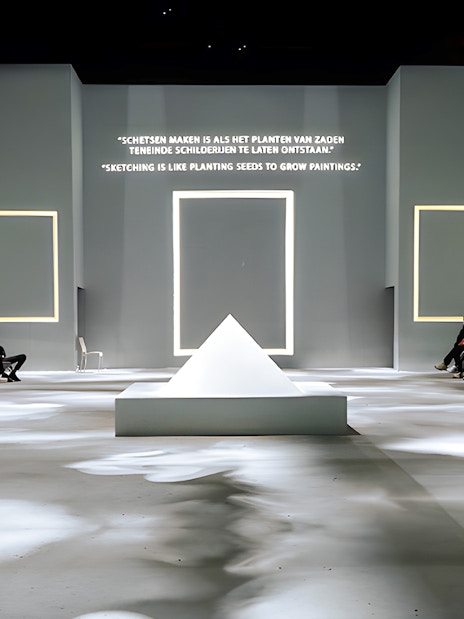 Guests seated at Van Gogh Exhibition in London, viewing illuminated quotes and frames.