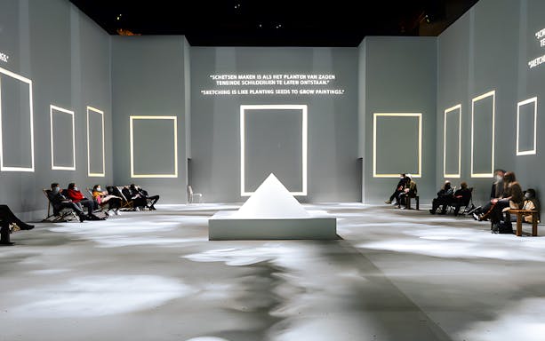 Guests seated at Van Gogh Exhibition in London, viewing illuminated quotes and frames.
