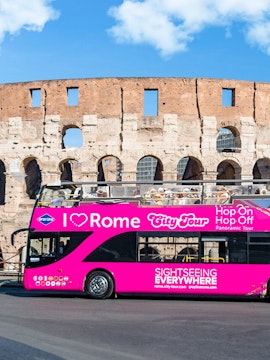 Hop-on Hop-off tour bus in front of the Colosseum, Rome.