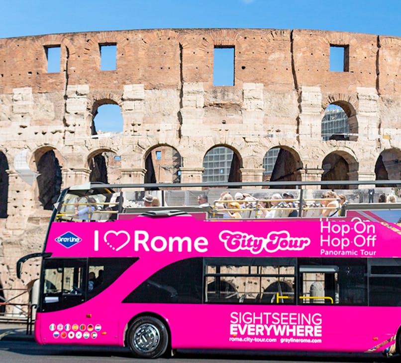Open-top bus touring near the Colosseum in Rome with I Love Rome Hop-on Hop-off tickets.