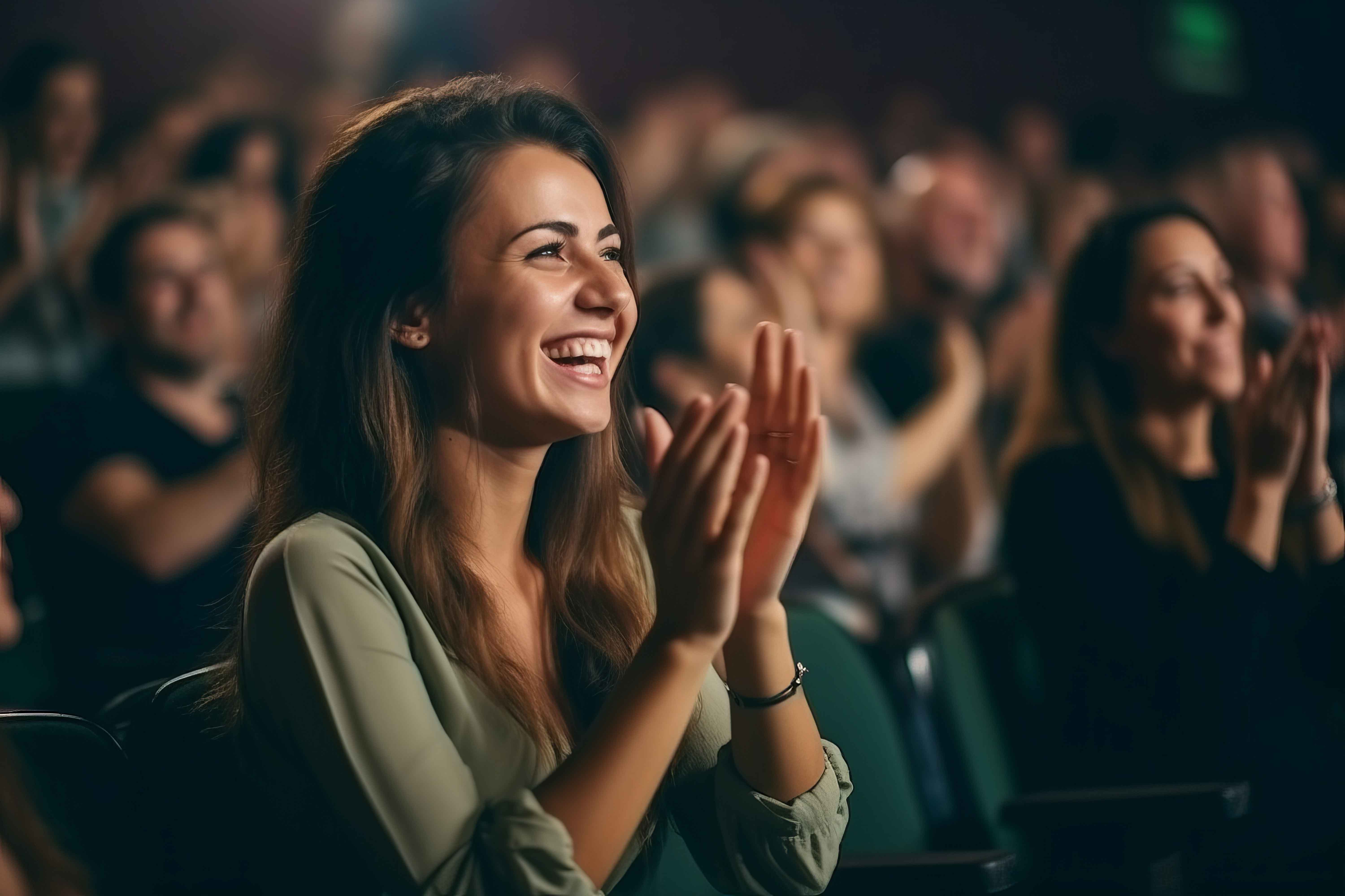 Audience member applauding at a theater event