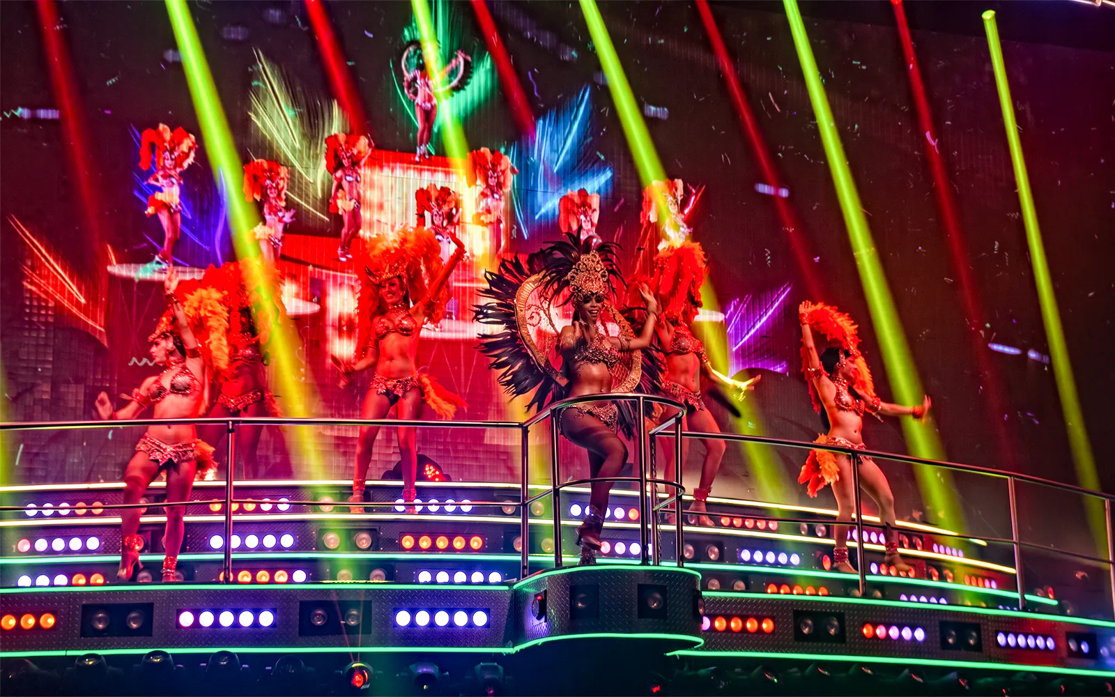 Performers in vibrant costumes on stage at Coco Bongo Club, Punta Cana.