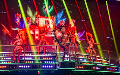 Performers in vibrant costumes on stage at Coco Bongo Club, Punta Cana.