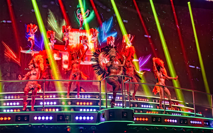 Performers in vibrant costumes on stage at Coco Bongo Club, Punta Cana.