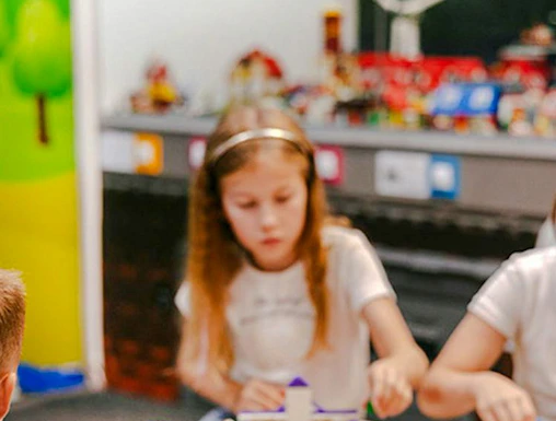 Children building with colorful bricks at Museum of Bricks exhibit.