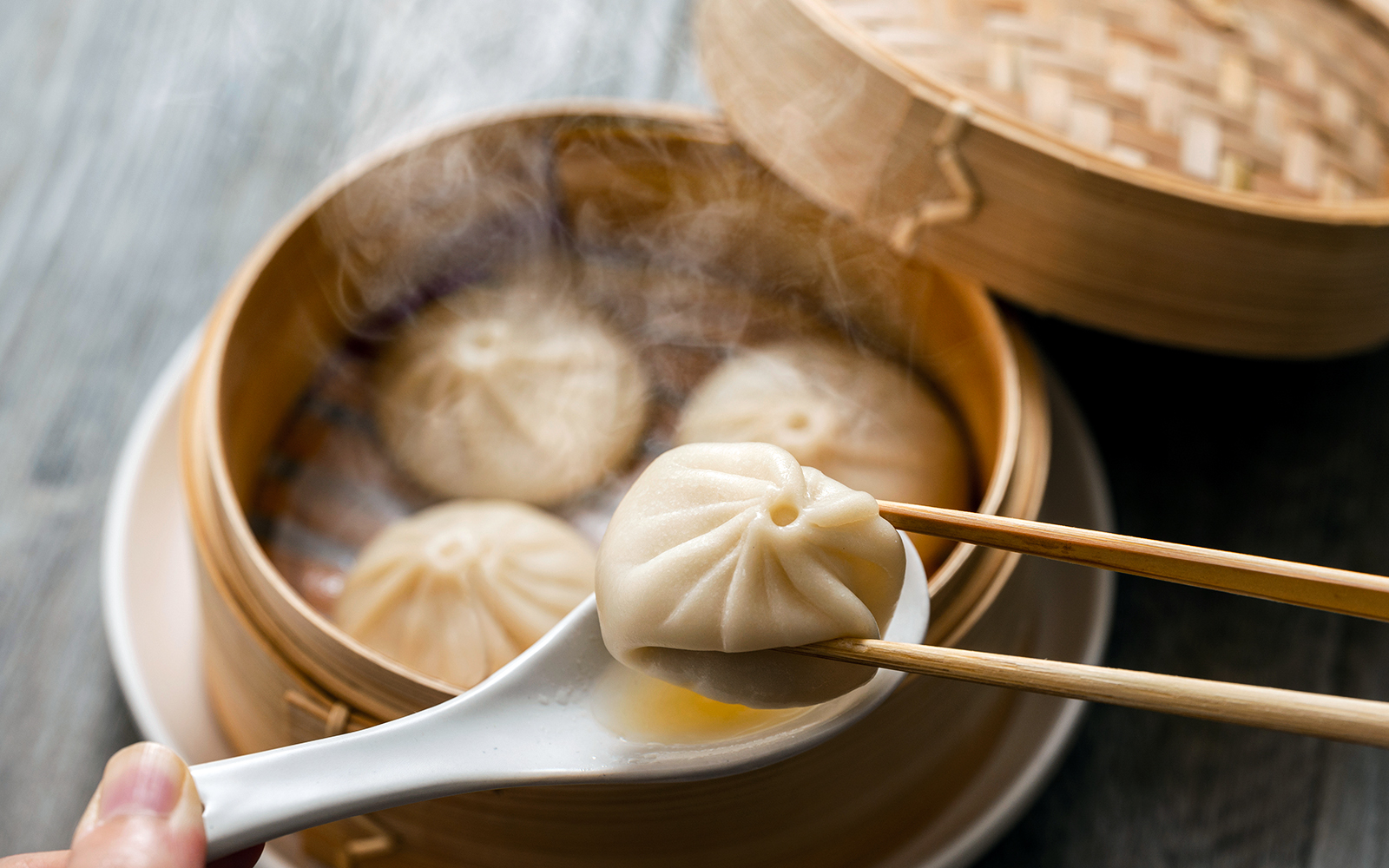 Xiao long bao dumplings in a bamboo steamer