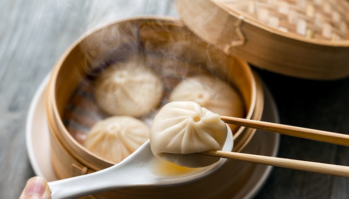 Xiao long bao dumplings in a bamboo steamer