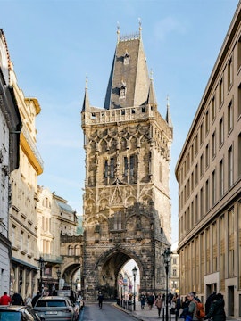 Powder Tower in Prague with Gothic architecture and street view.