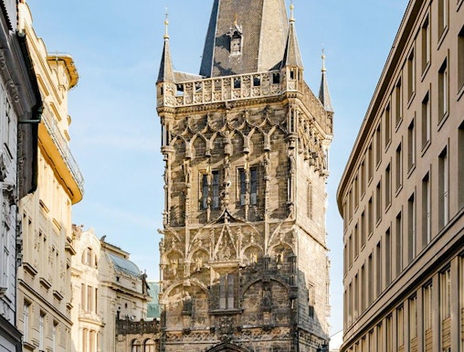 Powder Tower in Prague with Gothic architecture and street view.