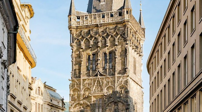 Powder Tower in Prague with Gothic architecture and street view.
