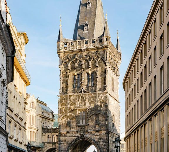 Powder Tower in Prague with Gothic architecture and street view.
