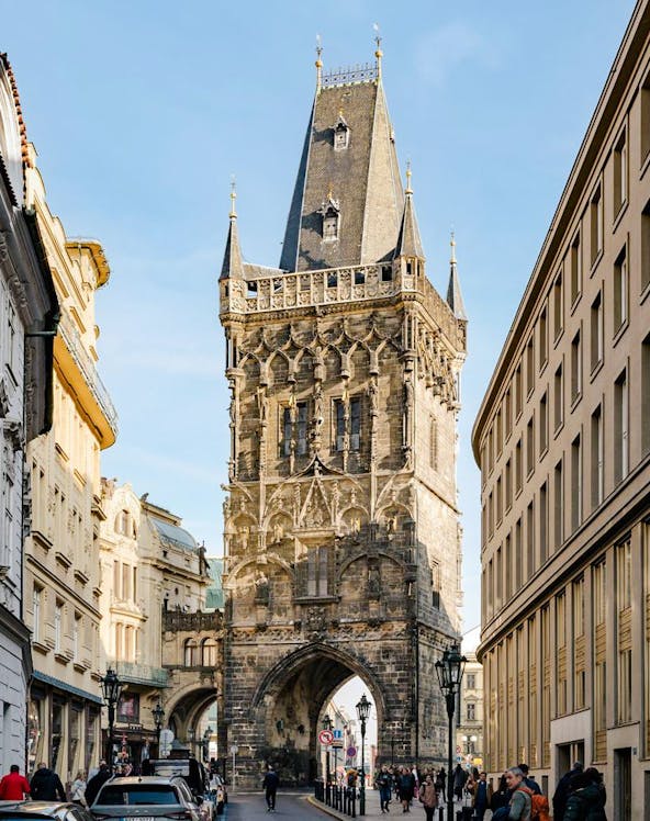 Powder Tower in Prague with Gothic architecture and street view.