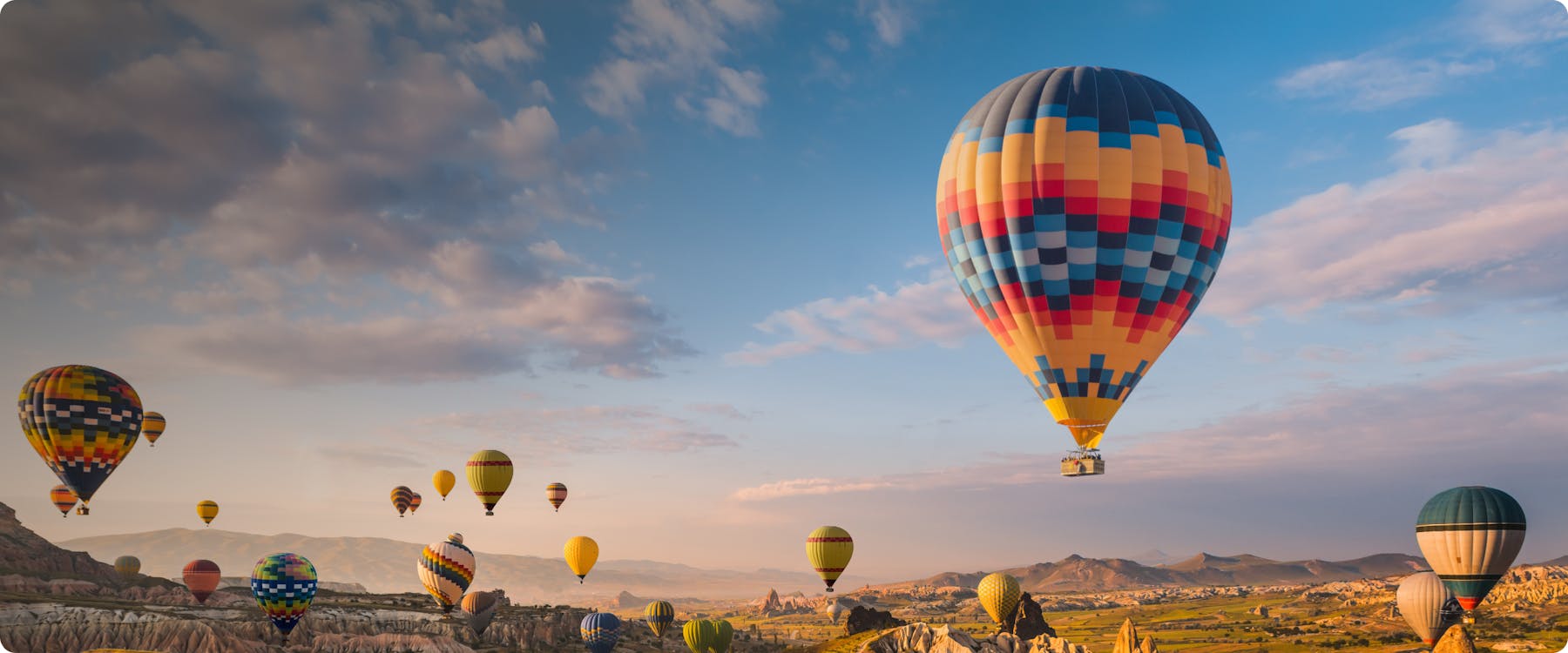 Hot air balloons over Cappadocia's unique rock formations, Turkey.