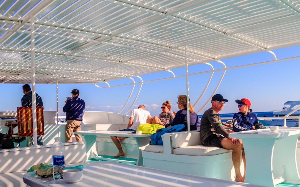 People relaxing on a cruise deck during a Dolphin Watching Boat Tour, Red Sea, Hurghada.