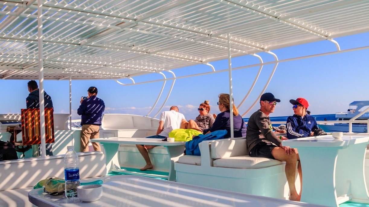 People relaxing on a cruise deck during a Dolphin Watching Boat Tour, Red Sea, Hurghada.
