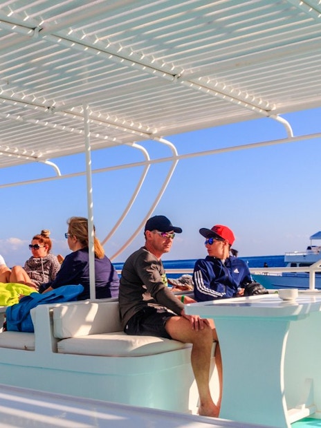 People relaxing on a cruise deck during a Dolphin Watching Boat Tour, Red Sea, Hurghada.