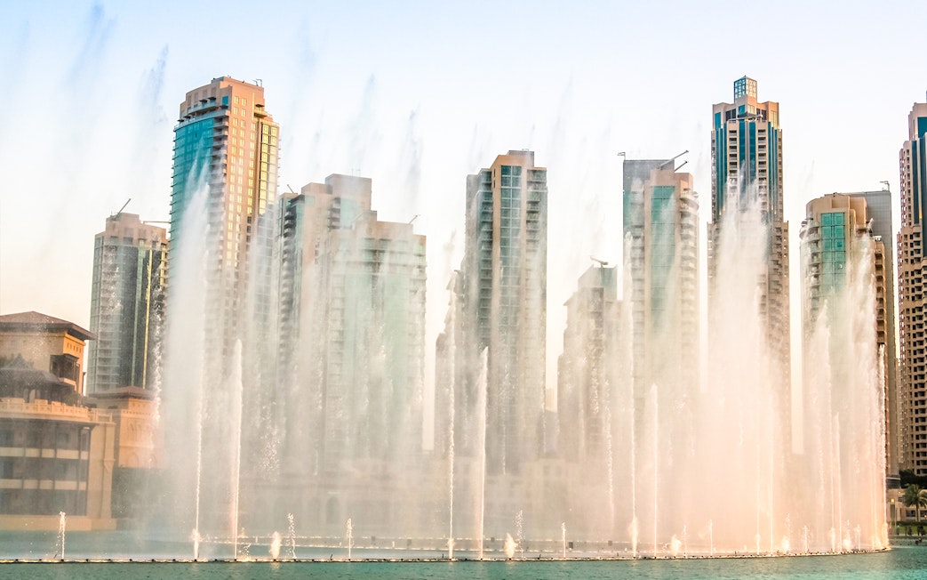 Dubai Fountain show with skyscrapers in the background during a half-day sightseeing tour.