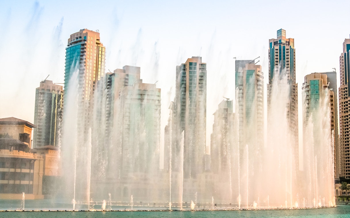 Dubai Fountain show with skyscrapers in the background during a half-day sightseeing tour.