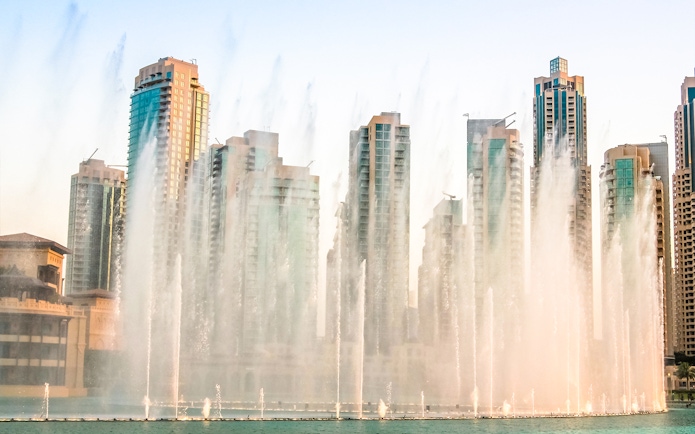 Dubai Fountain show with skyscrapers in the background during a half-day sightseeing tour.