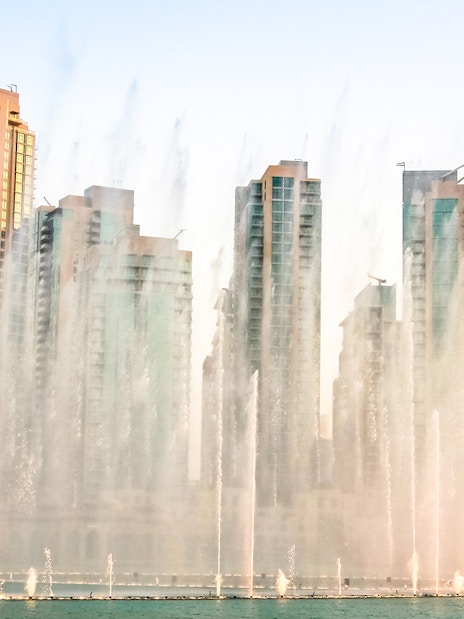 Dubai Fountain show with skyscrapers in the background during a half-day sightseeing tour.