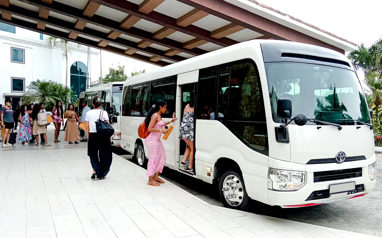 Shuttle bus loading passengers at Tocumen Airport for Panama City hotel transfer.