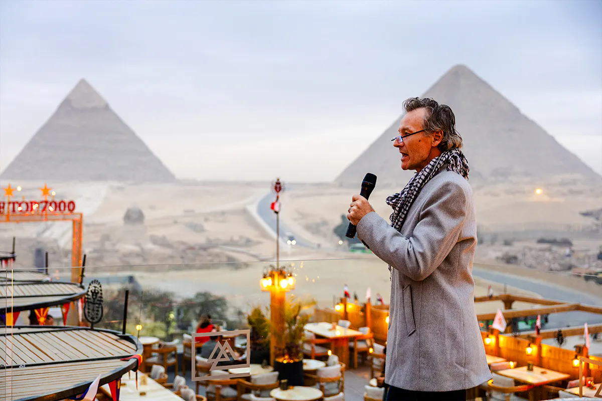 Dinner event at Rooftop7000 with view of Giza Pyramids in the background.