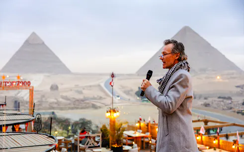 Dinner event at Rooftop7000 with view of Giza Pyramids in the background.
