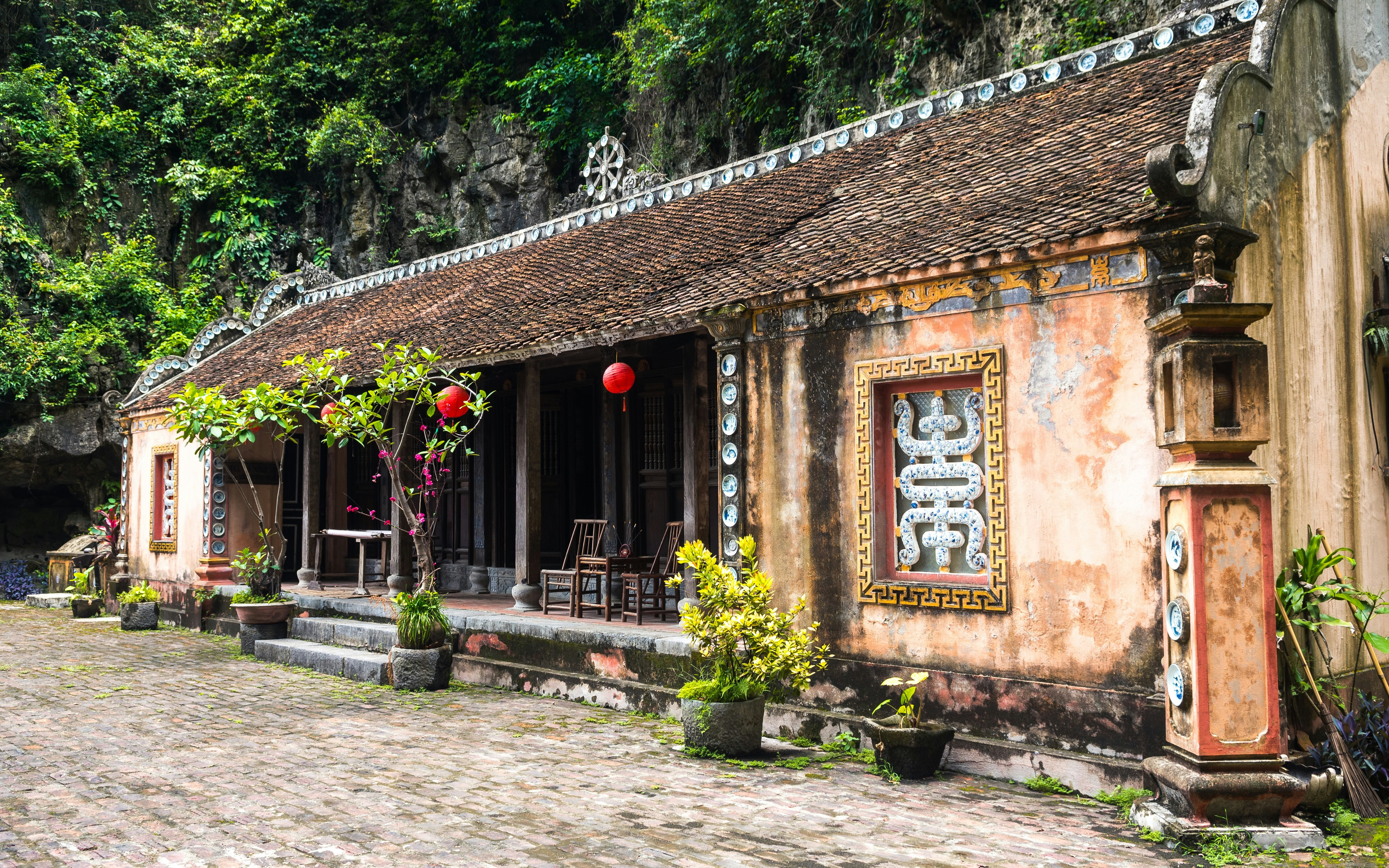 Ancient building with red lanterns in Hoa Lu, Ninh Binh, Vietnam.