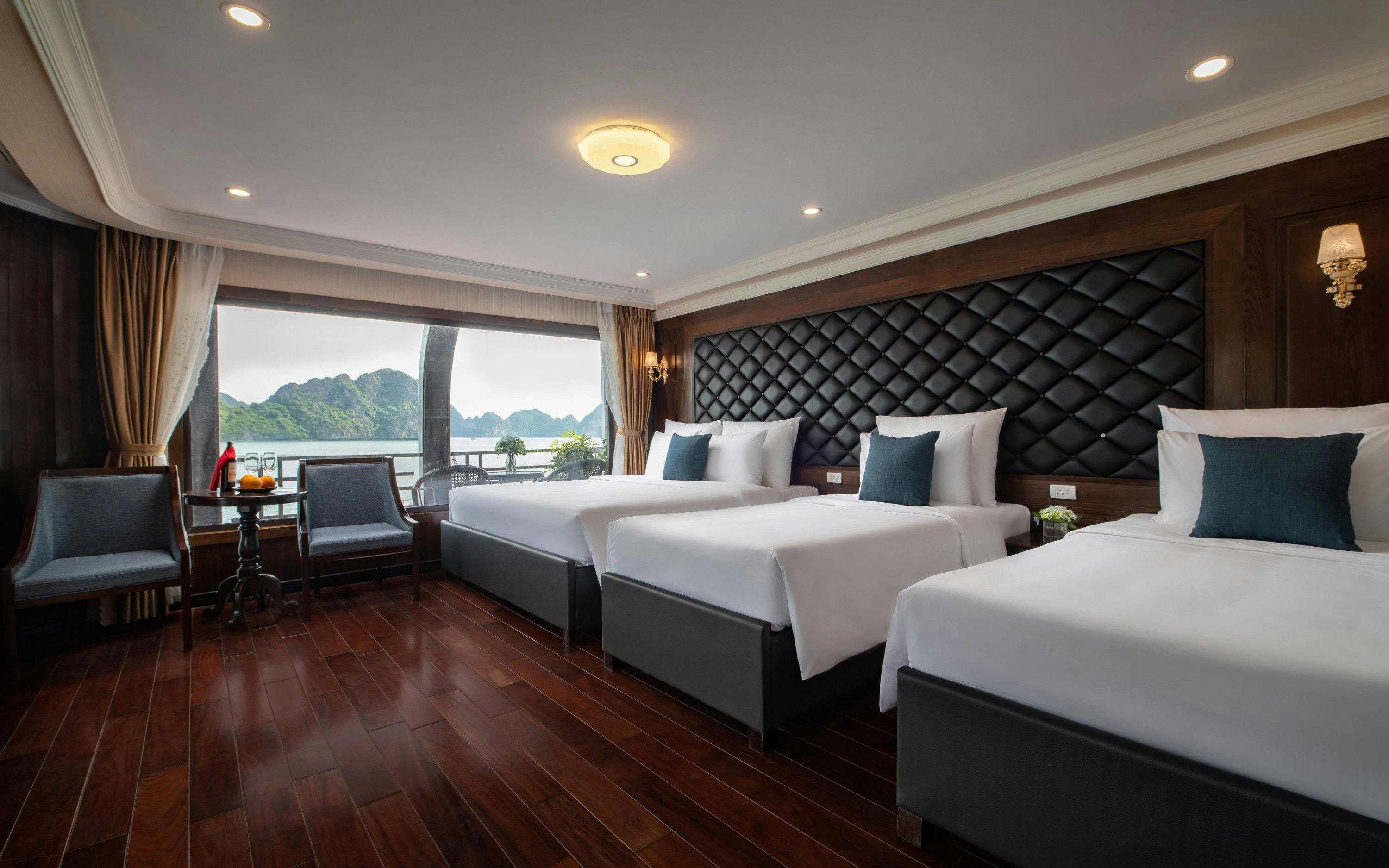 Cruise cabin with three beds and ocean view in Lan Ha Bay.