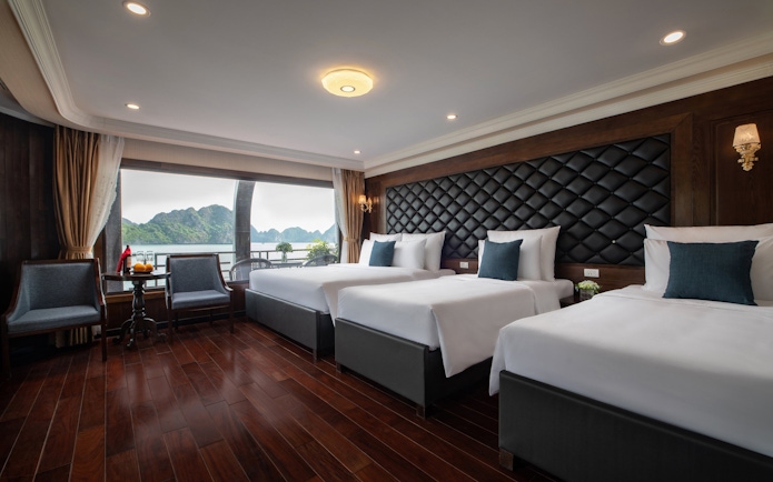 Cruise cabin with three beds and ocean view in Lan Ha Bay.
