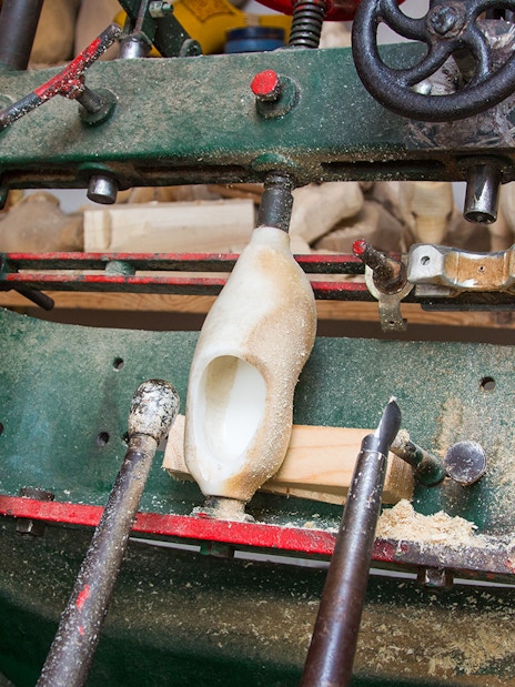 Wooden clog being crafted on a machine in Zaanse Schans, Netherlands.